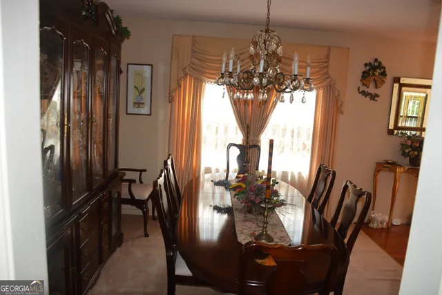 a view of a dining room with furniture and chandelier