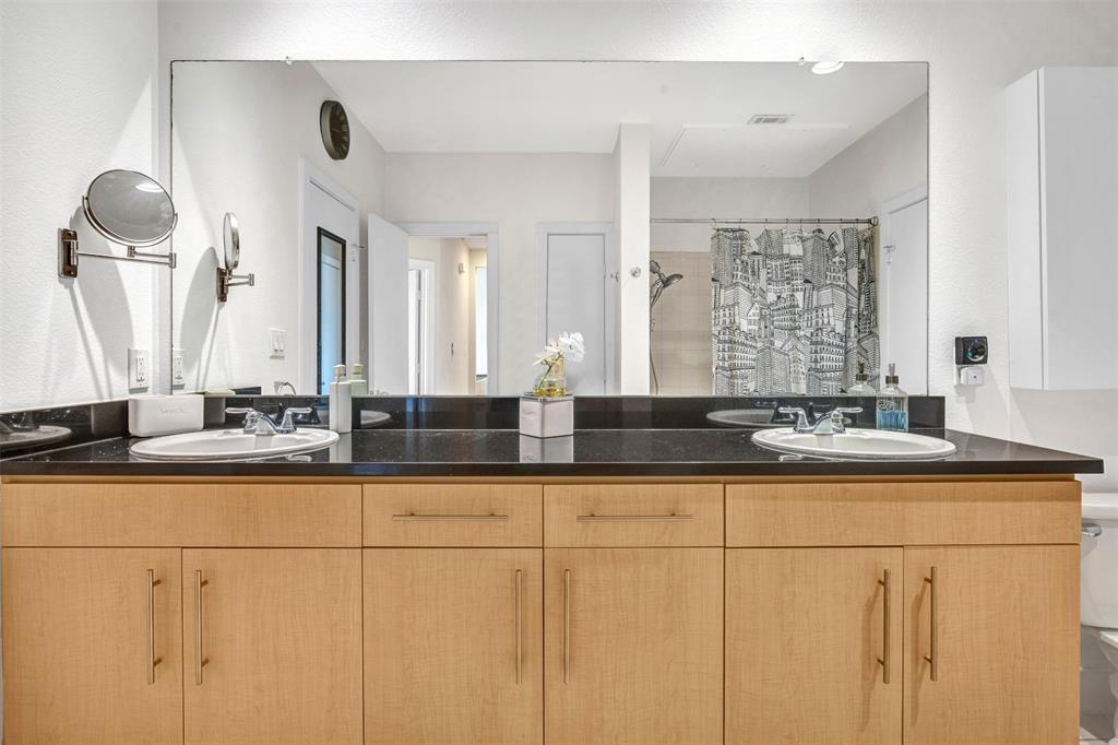 4414 Cedar Springs Road, Unit 314 Dallas, TX 75219 - Photo 17 of 26 a bathroom with sinks a vanity and a large mirror