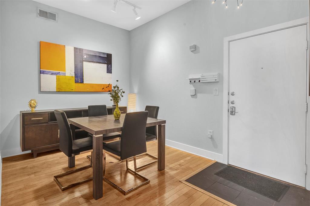 4414 Cedar Springs Road, Unit 314 Dallas, TX 75219 - Photo 4 of 26 a view of a workspace with furniture and wooden floor
