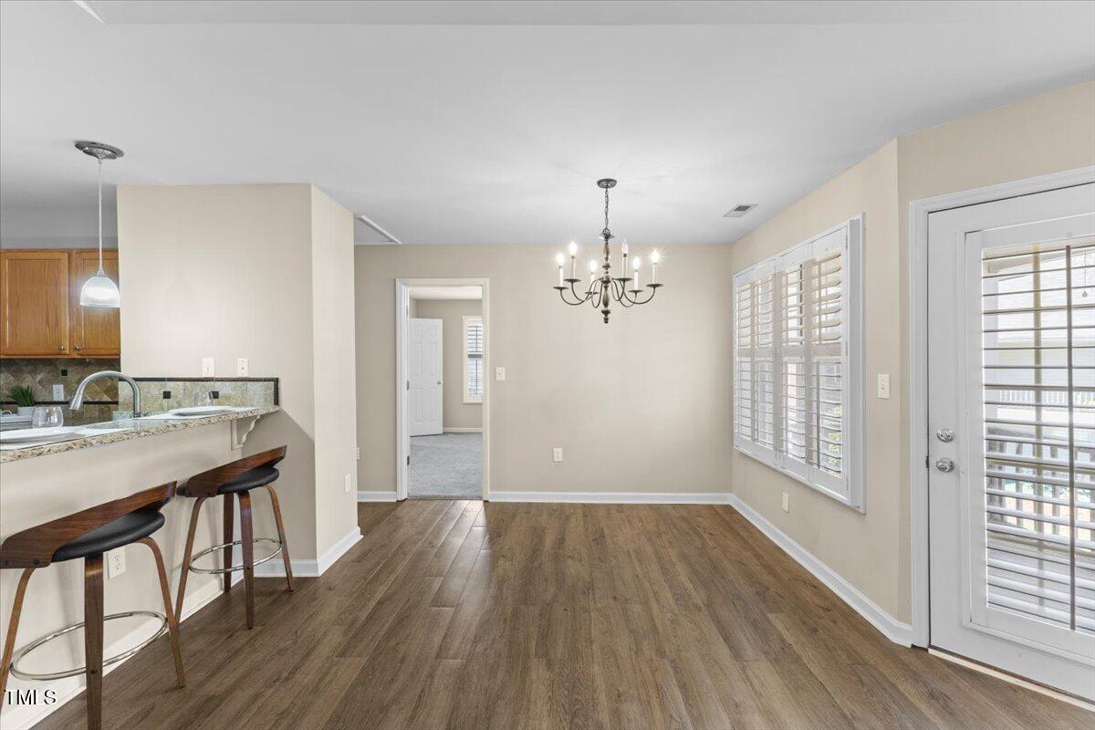 723 Renshaw Court Cary, NC 27518 - Photo 17 of 34 a view of a room with wooden floor and windows