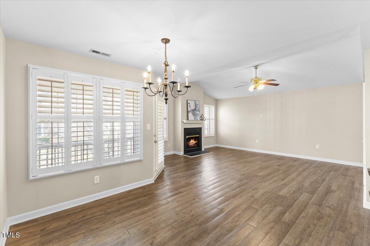 723 Renshaw Court Cary, NC 27518 - Photo 18 of 34 a view of a livingroom with wooden floor and a ceiling fan