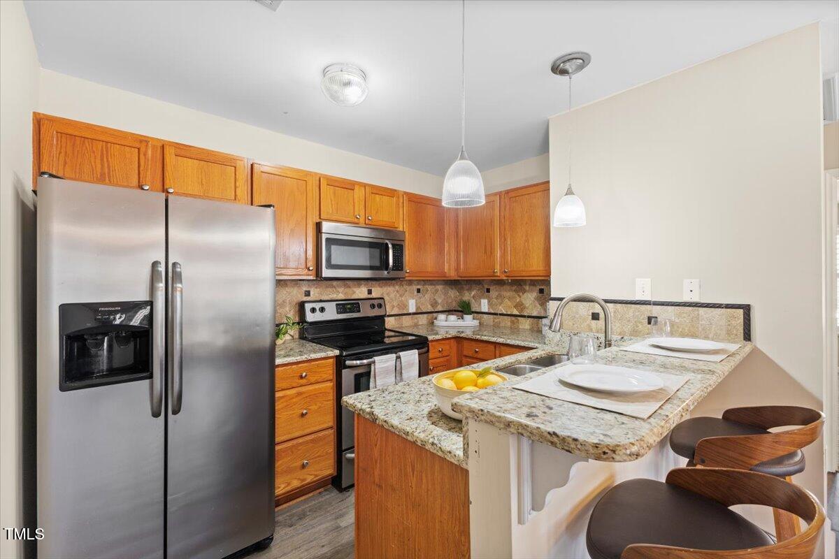 723 Renshaw Court Cary, NC 27518 - Photo 20 of 34 a kitchen with a sink a refrigerator and cabinets