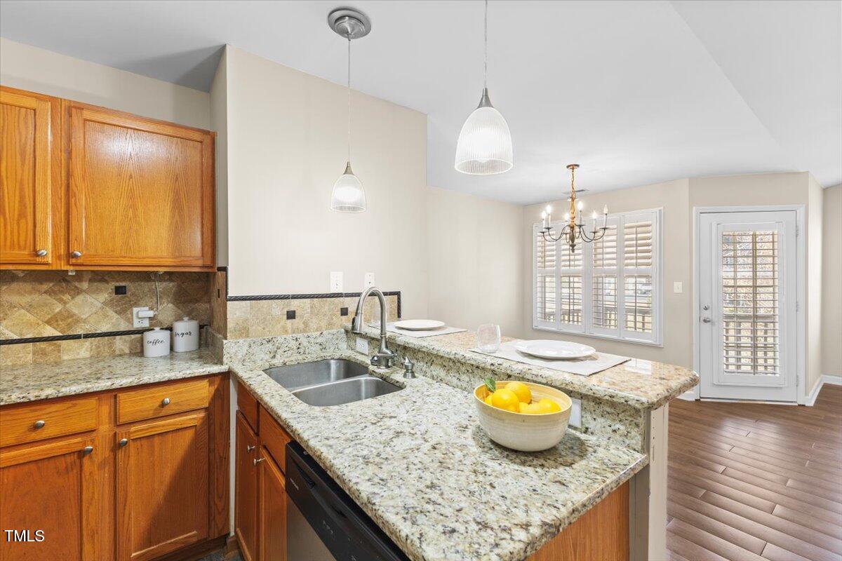 723 Renshaw Court Cary, NC 27518 - Photo 22 of 34 a kitchen with a sink and a granite counter top