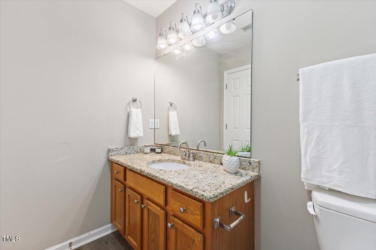 723 Renshaw Court Cary, NC 27518 - Photo 27 of 34 a bathroom with a sink and a mirror