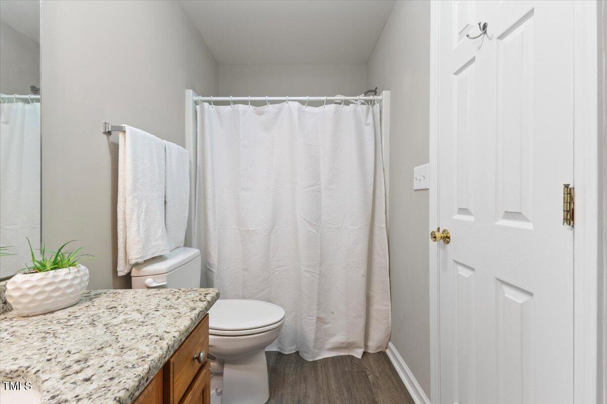 723 Renshaw Court Cary, NC 27518 - Photo 28 of 34 a bathroom with a granite countertop sink toilet and shower