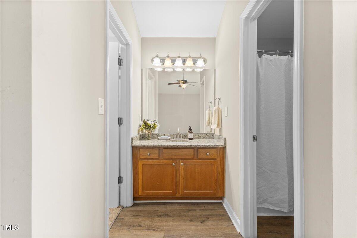 723 Renshaw Court Cary, NC 27518 - Photo 8 of 34 a bathroom with a granite countertop sink and a mirror