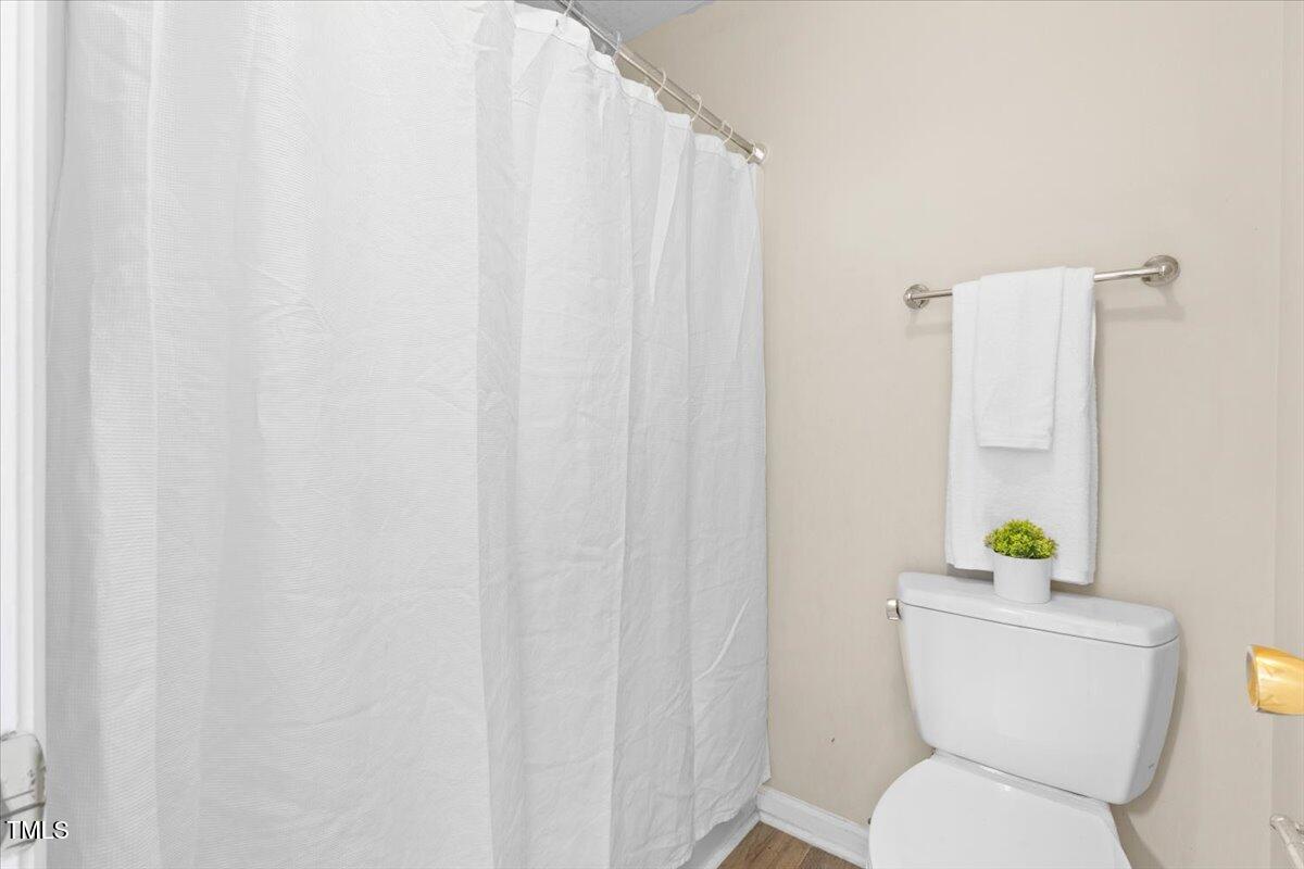 723 Renshaw Court Cary, NC 27518 - Photo 9 of 34 a white toilet sitting next to a white curtain
