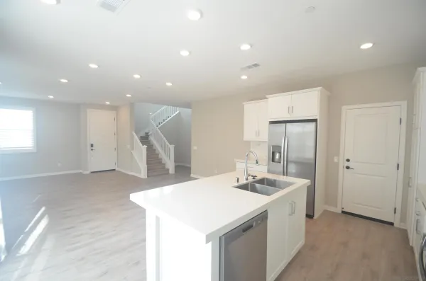 a room with a sink and a refrigerator