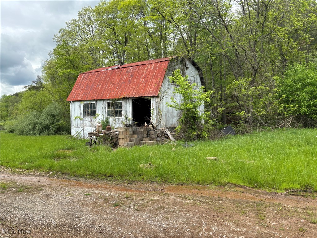 212 Rost Road Walker, WV 26180 - Photo 17 of 29 View of shed with a forest view