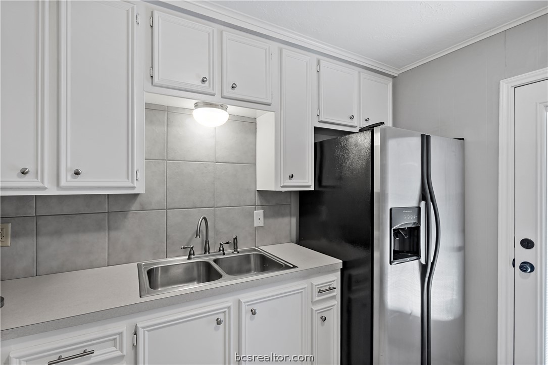 804 East 32nd Street Bryan, TX 77803 - Photo 11 of 22 a kitchen with stainless steel appliances granite countertop a refrigerator and a sink