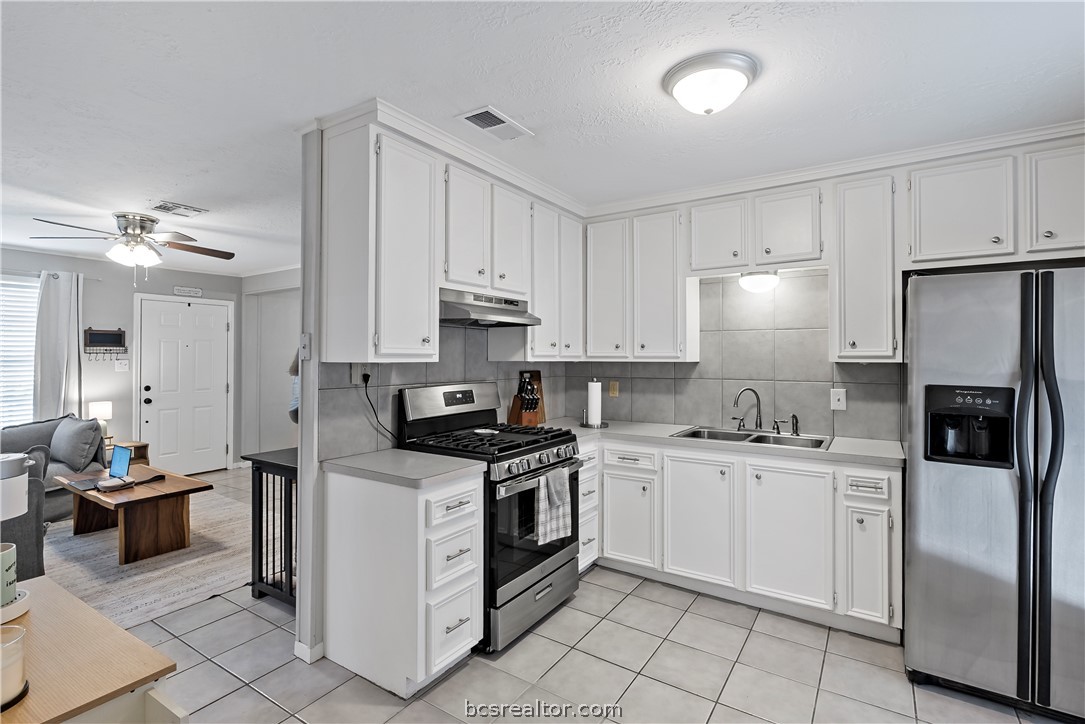 804 East 32nd Street Bryan, TX 77803 - Photo 13 of 22 a kitchen with stainless steel appliances a stove refrigerator sink and cabinets