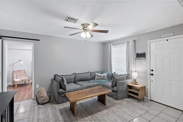 a living room with furniture a two chairs and a window