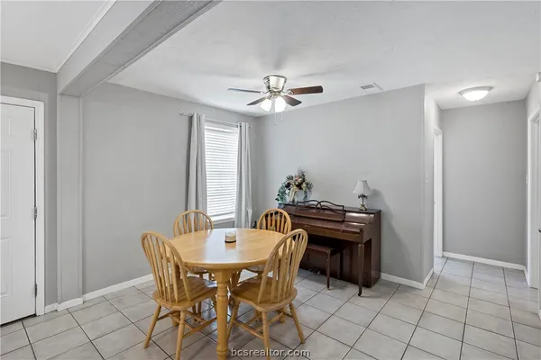 a dining room with furniture and wooden floor