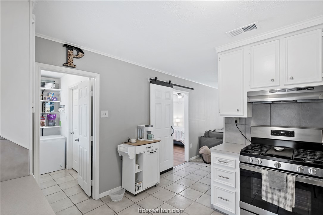 804 East 32nd Street Bryan, TX 77803 - Photo 9 of 22 a kitchen with white cabinets and appliances