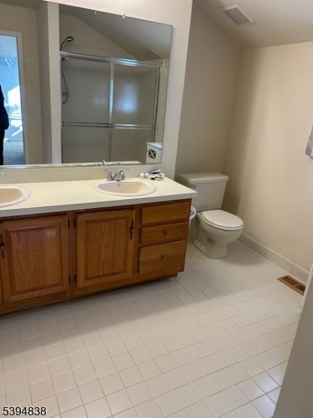 17 Crestmont Road Bedminster, NJ 07921 - Photo 9 of 20 a bathroom with a toilet sink and mirror
