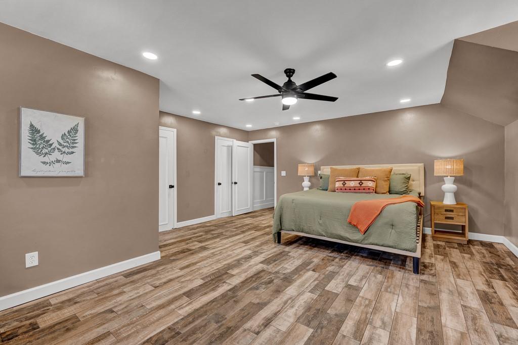 6117 Gainsborough Road Amarillo, TX 79106 - Photo 33 of 40 a bedroom with a large bed and a chandelier