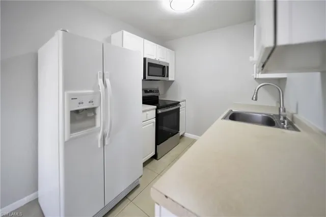 a kitchen with a refrigerator and a sink