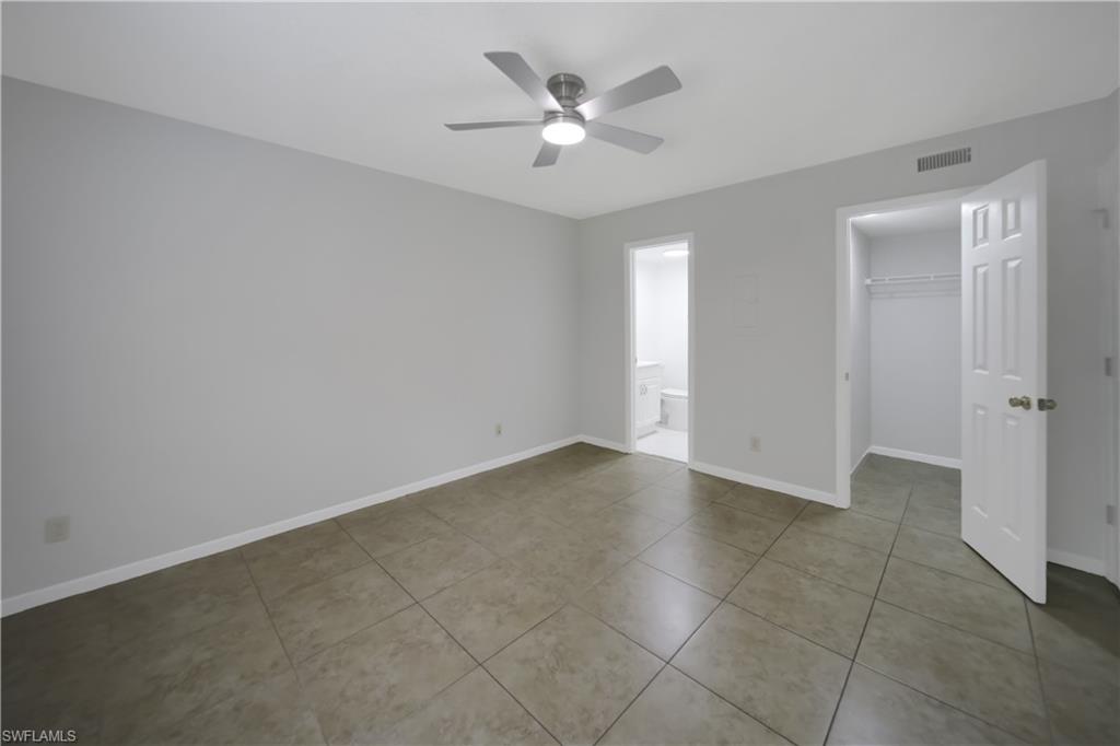 4621 Bayshore Drive, Unit Q4 Naples, FL 34112 - Photo 7 of 12 an empty room with closet and a ceiling fan