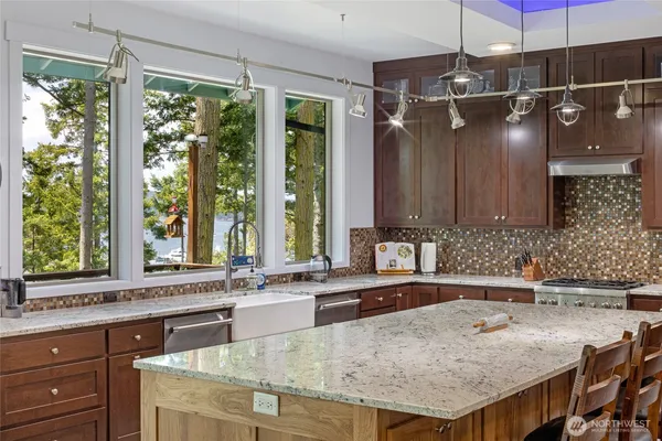 a kitchen with granite countertop a sink and a window
