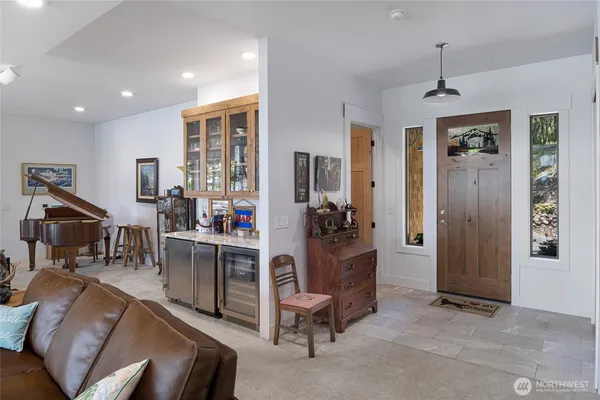 a living room with furniture a dining table and chairs with wooden floor