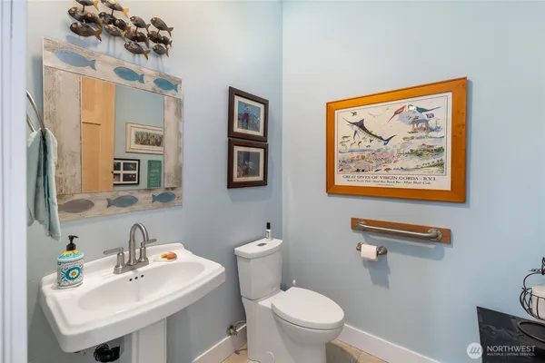 a bathroom with a sink mirror and toilet