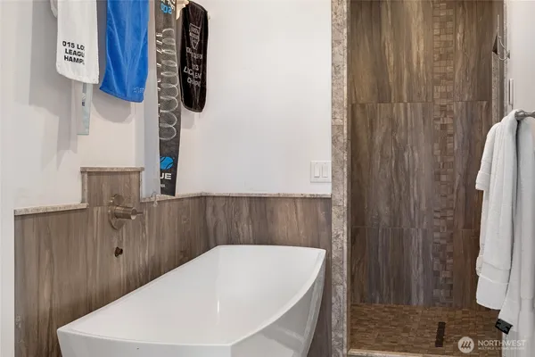 a bathroom with a bathtub and a shower