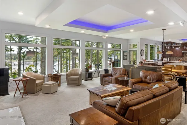 a living room with furniture and large windows