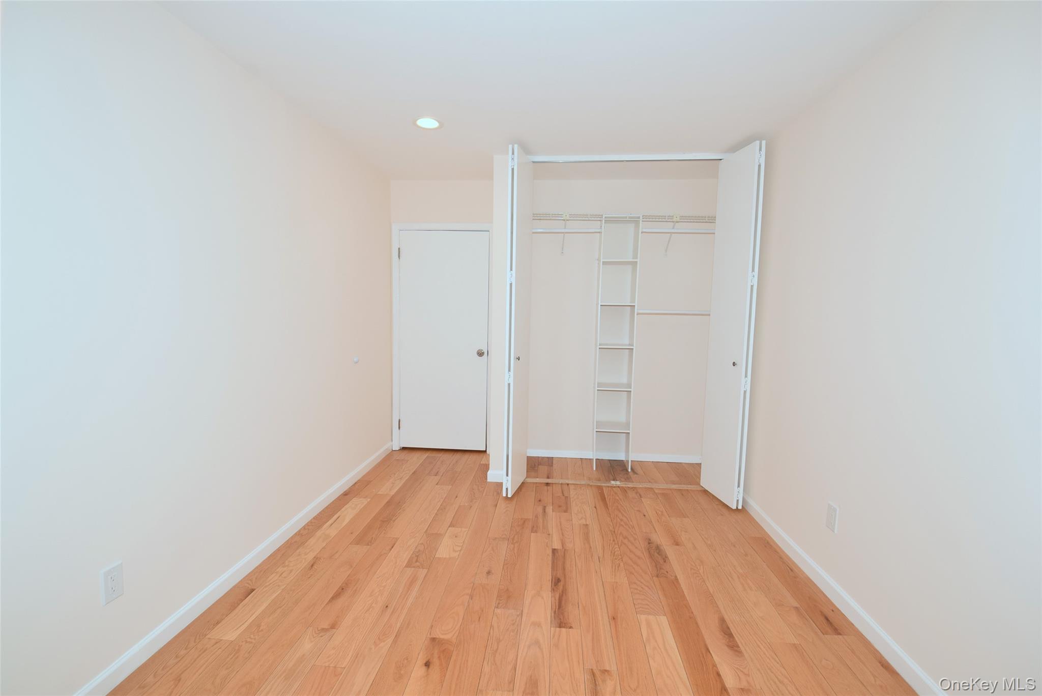 206-14 Emily Road, Unit 42L Queens, NY 11360 - Photo 11 of 14 a view of a room with wooden floor