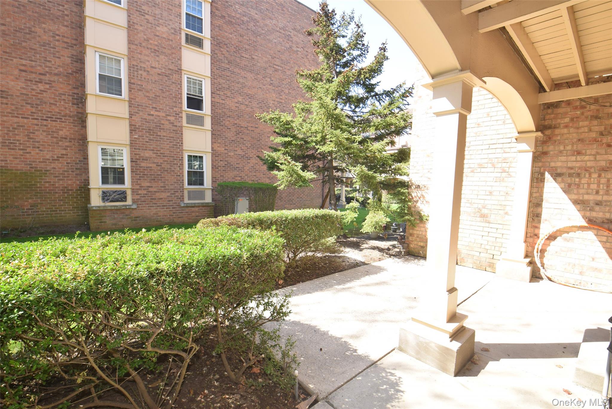 206-14 Emily Road, Unit 42L Queens, NY 11360 - Photo 14 of 14 a view of a house with a yard