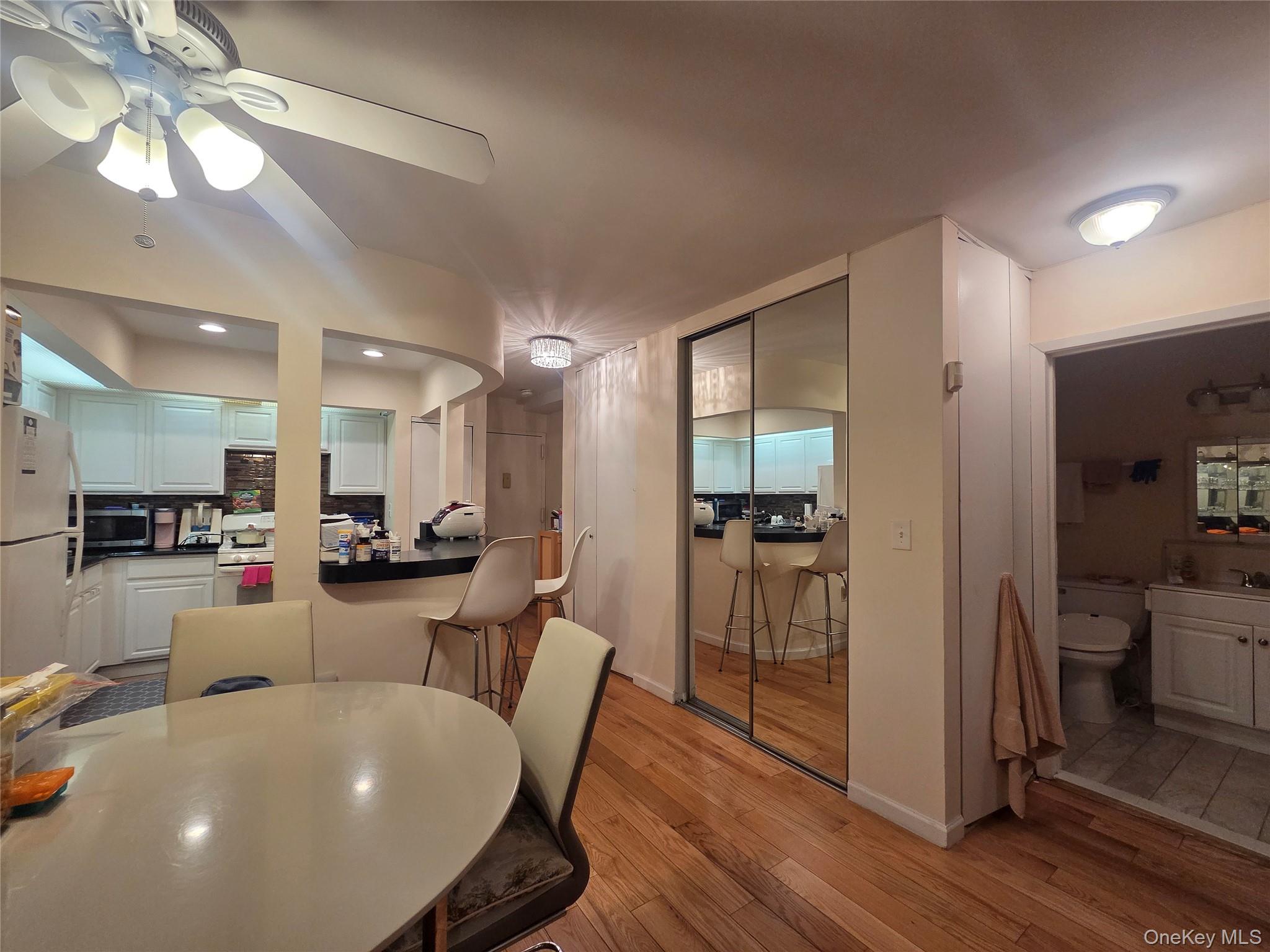 206-14 Emily Road, Unit 42L Queens, NY 11360 - Photo 6 of 9 a view of a dining room with furniture and wooden floor