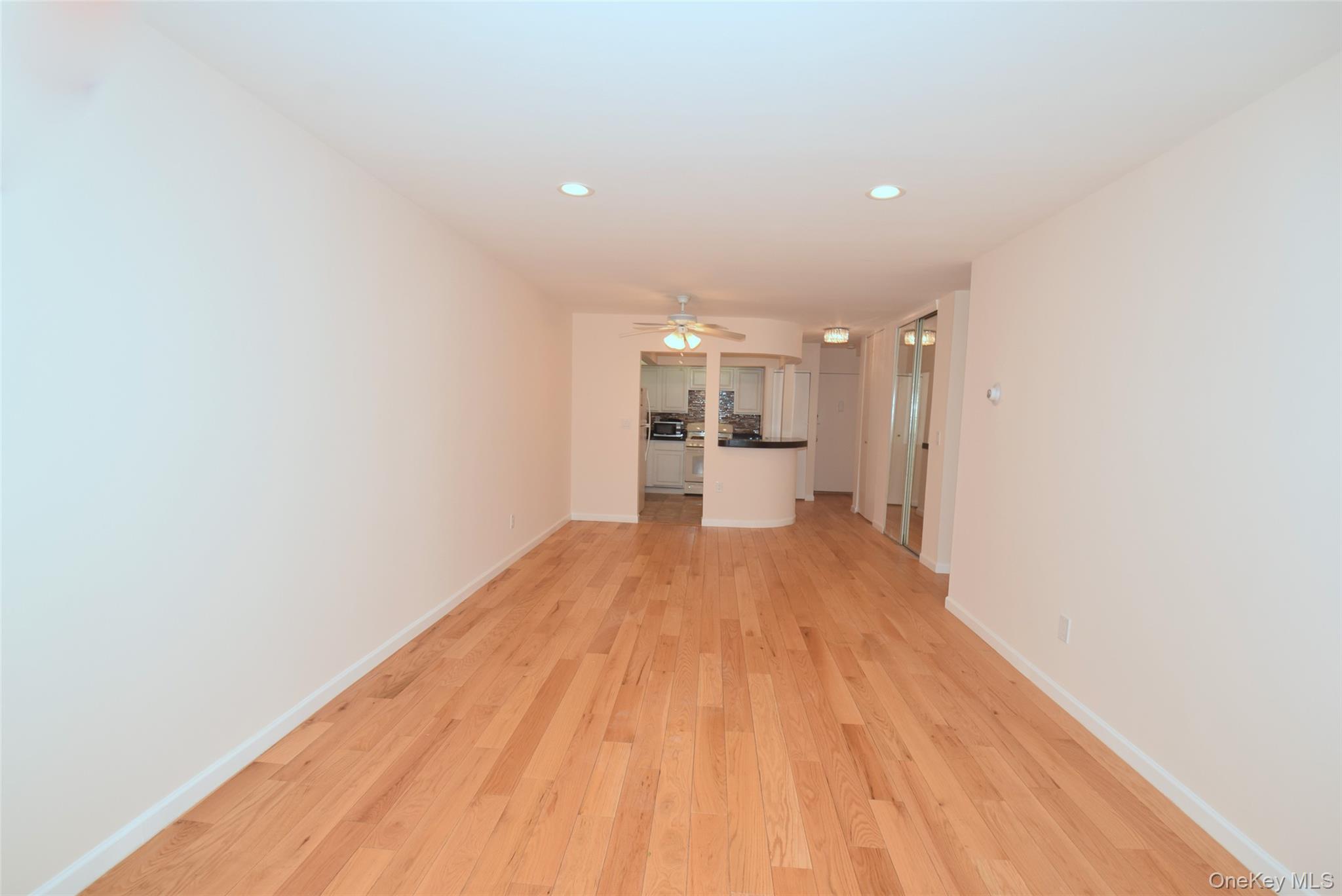 206-14 Emily Road, Unit 42L Queens, NY 11360 - Photo 8 of 14 a view of a room with wooden floor