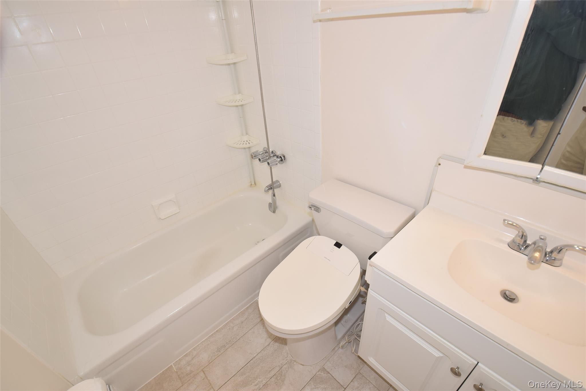 206-14 Emily Road, Unit 42L Queens, NY 11360 - Photo 9 of 14 a bathroom with a sink toilet and shower