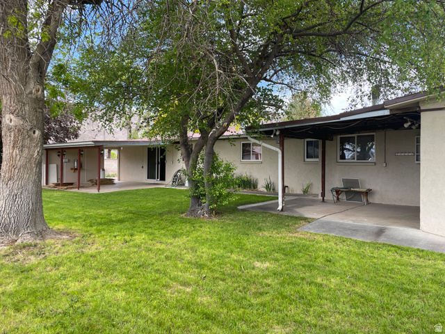 438 East Main Street Elsinore, UT 84724 - Photo 5 of 43 Expansive green lawn with mature shade trees, and two covered concrete patios