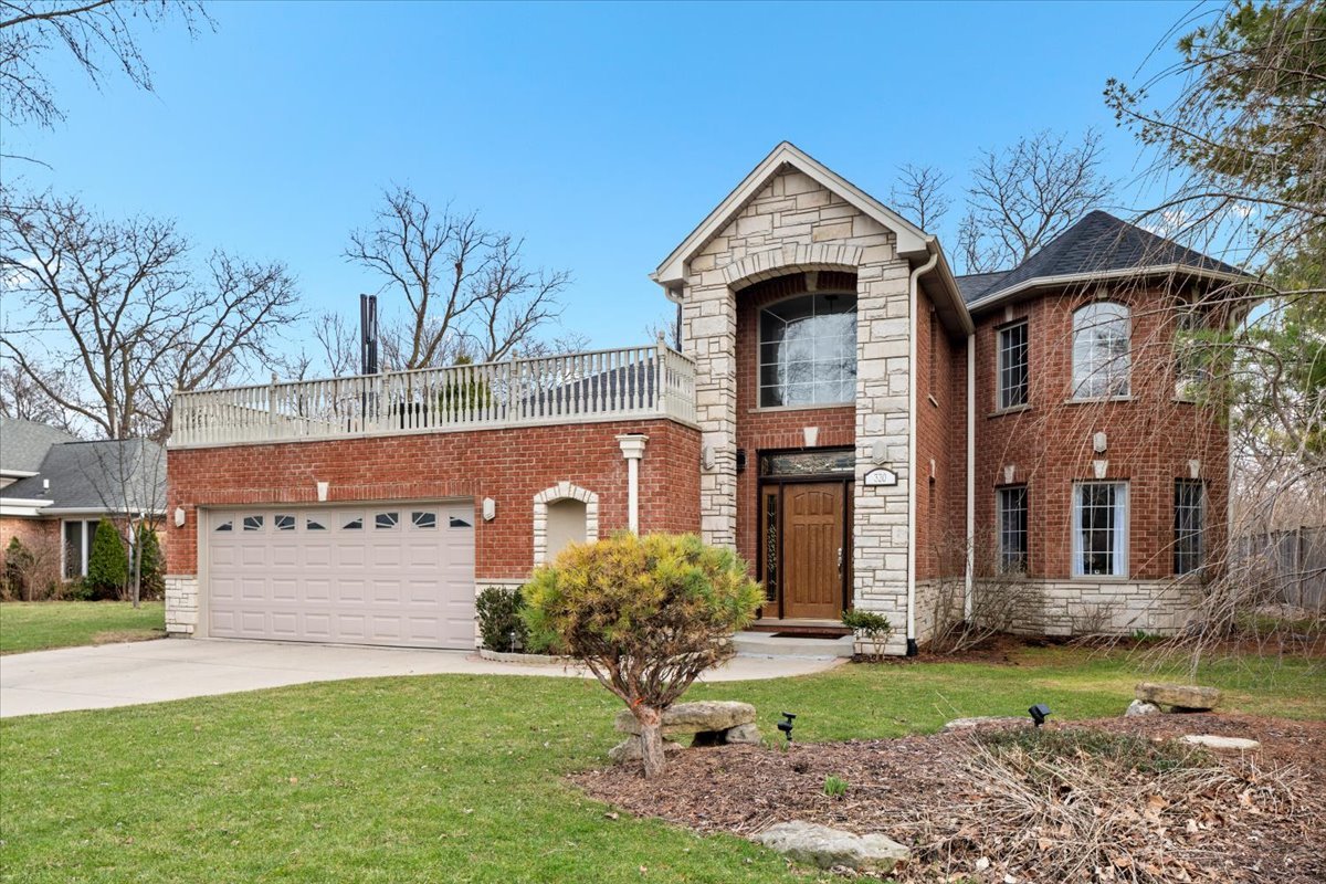 320 Beverly Drive Wilmette, IL 60091 - Photo 1 of 38 a front view of a house with garden