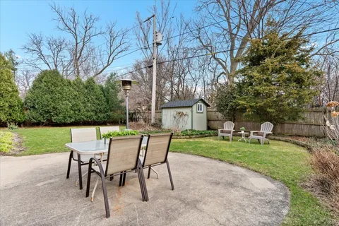 a view of a chairs and table in backyard of the house