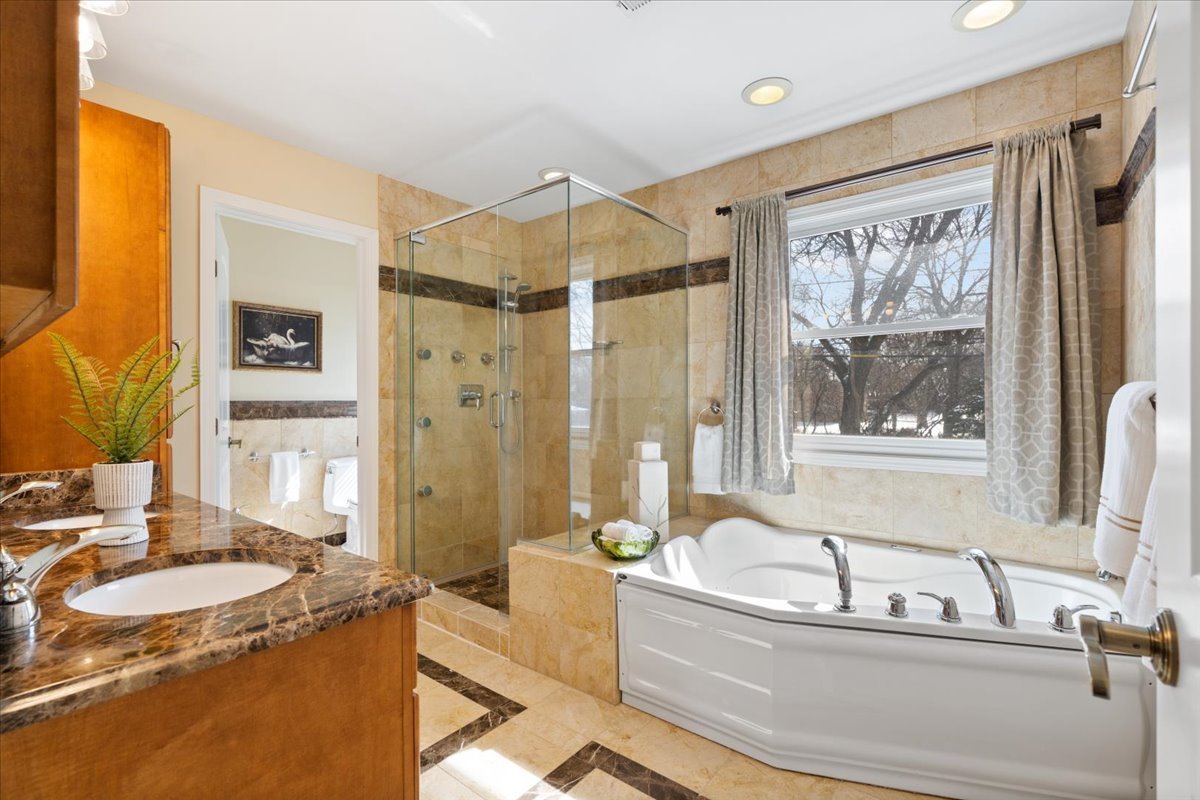 320 Beverly Drive Wilmette, IL 60091 - Photo 21 of 38 a bathroom with a tub a sink and a window