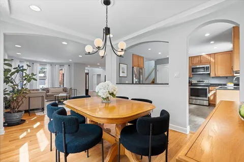 a view of a dining room with furniture and a chandelier
