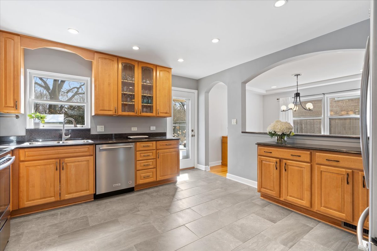 320 Beverly Drive Wilmette, IL 60091 - Photo 9 of 38 a large kitchen with stainless steel appliances granite countertop a stove a sink and a refrigerator