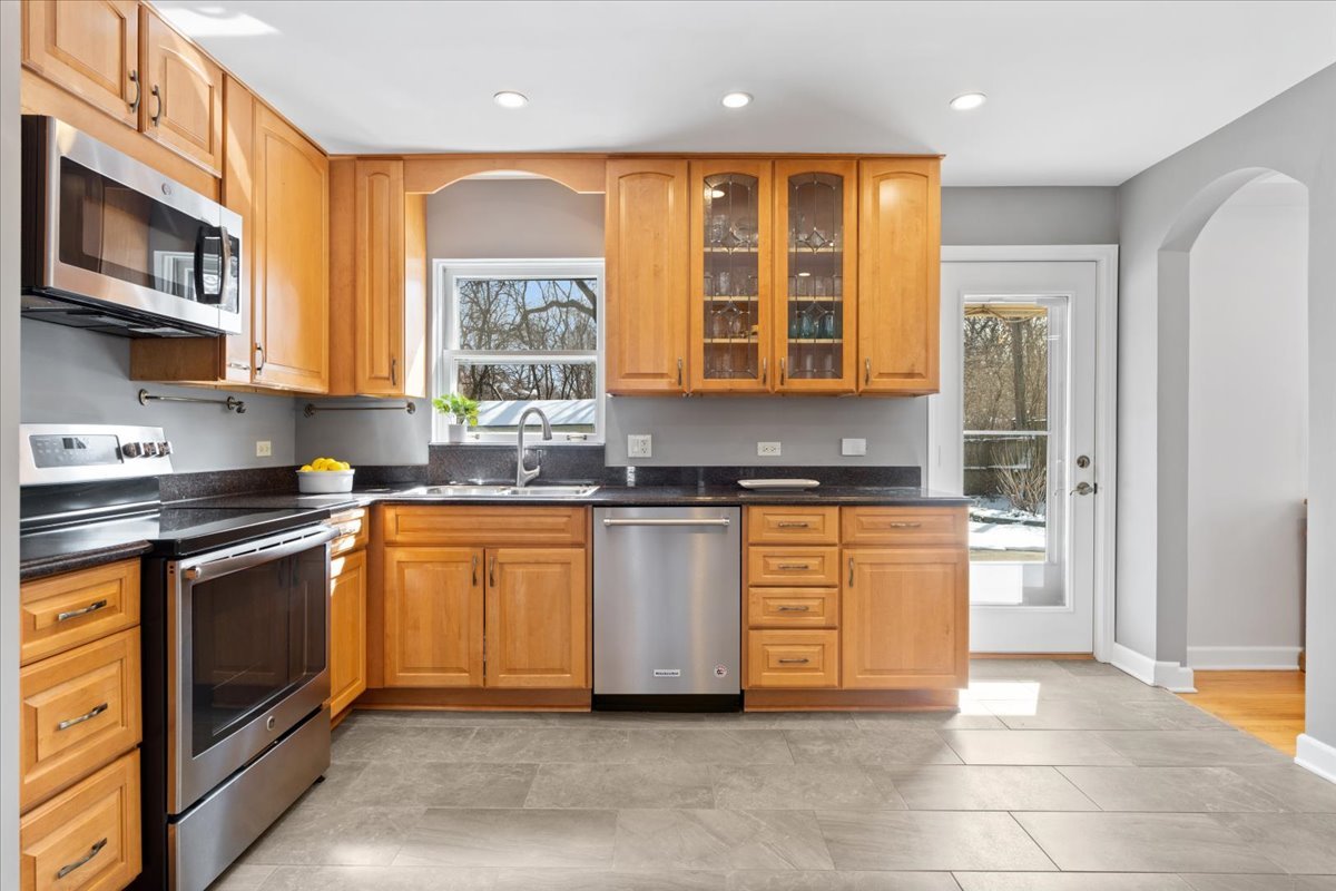 320 Beverly Drive Wilmette, IL 60091 - Photo 10 of 38 a kitchen with stainless steel appliances granite countertop a stove a sink and a microwave