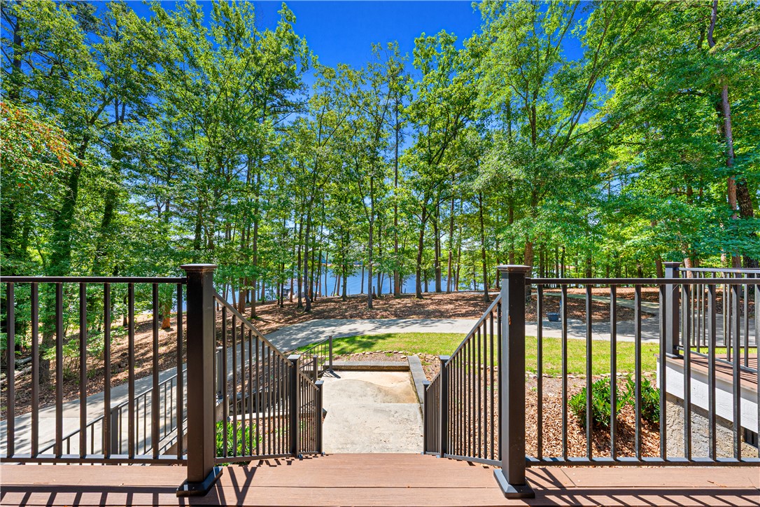 285 Bertha Allen Road Westminster, SC 29693 - Photo 30 of 50 Steps descend to a serene waterfront surrounded by lush trees, offering direct lake access.