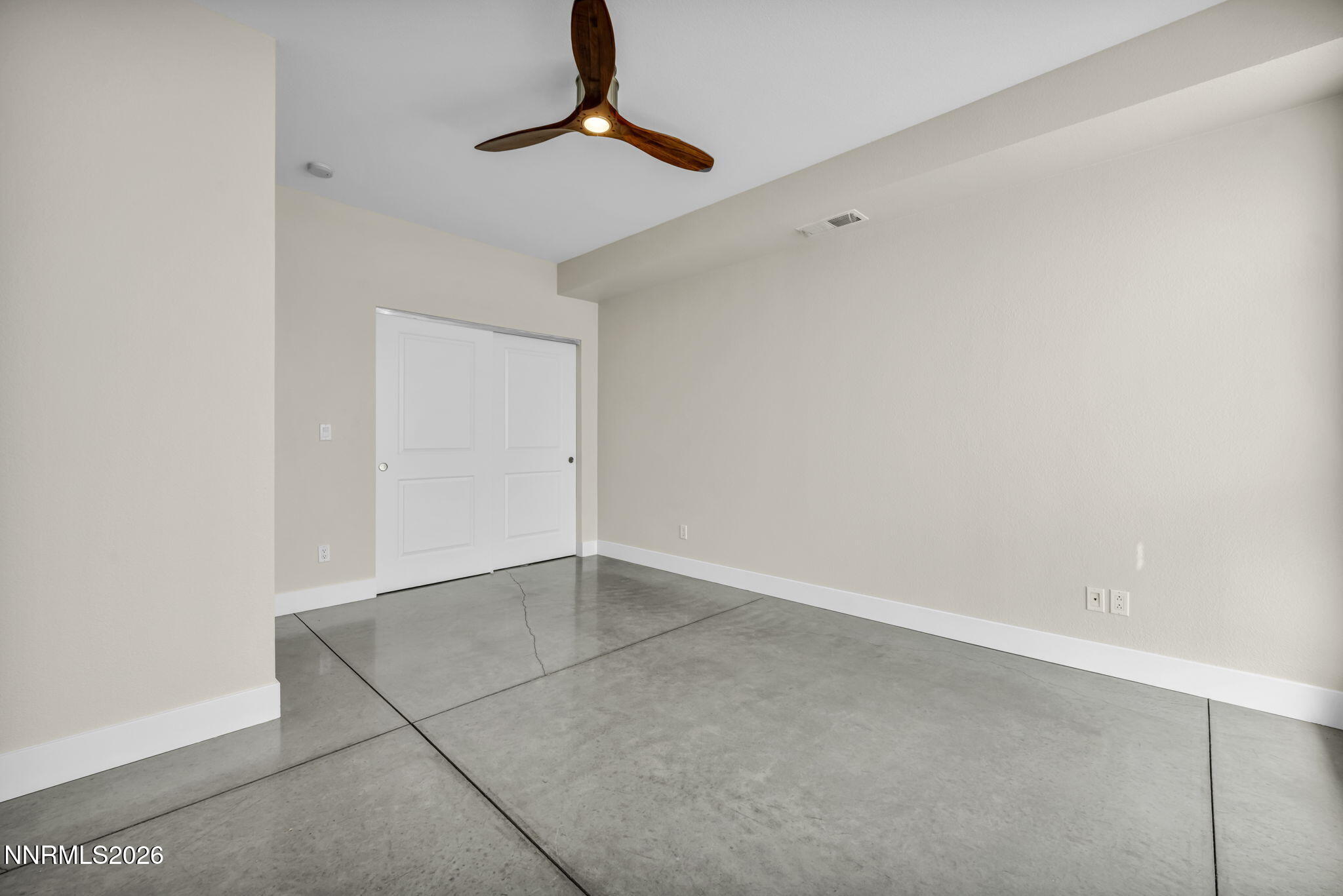 326 State Street Reno, NV 89501 - Photo 8 of 49 an empty room with a ceiling fan and carpet