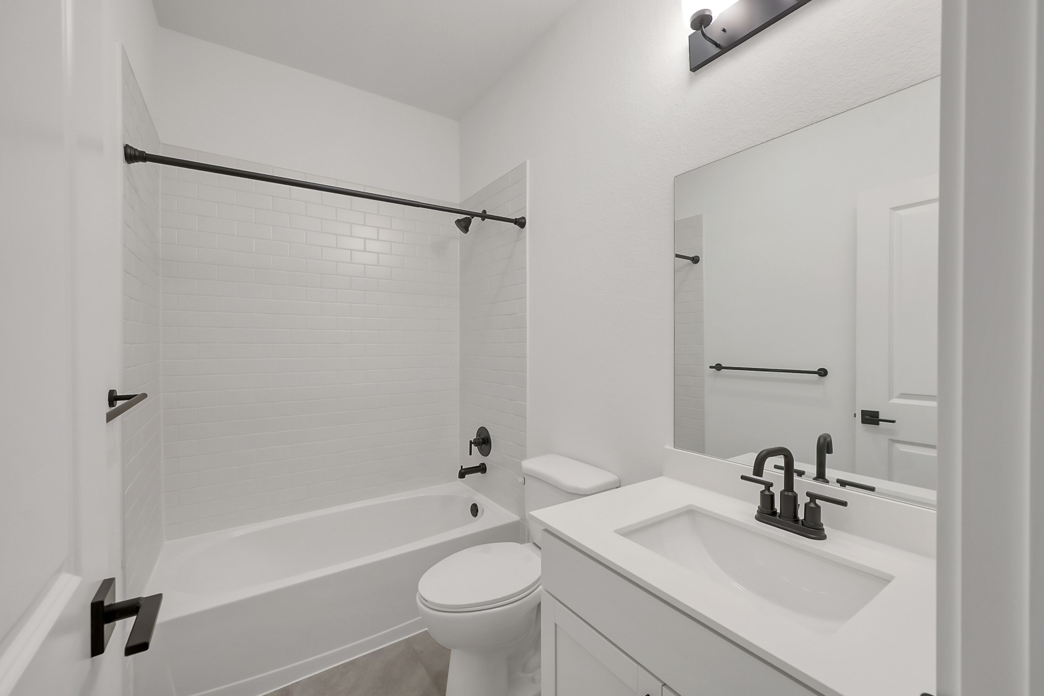 516 Monarch Trail Huntsville, TX 77340 - Photo 16 of 20 a bathroom with a sink mirror toilet and bathtub