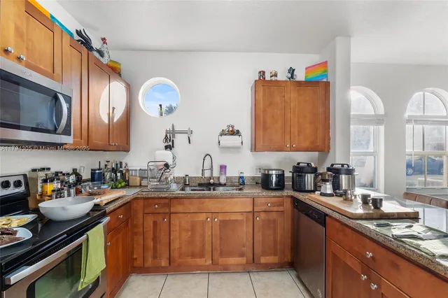 a view of a kitchen with a sink and cabinets