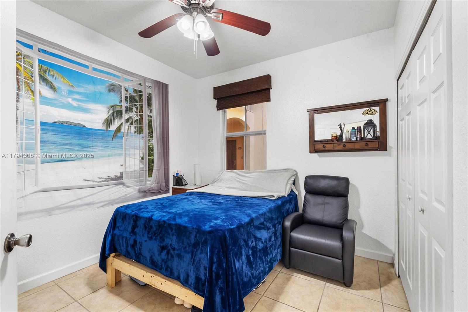 10012 Northwest 7th Street, Unit 107 Miami, FL 33172 - Photo 19 of 44 a bedroom with furniture and a large window