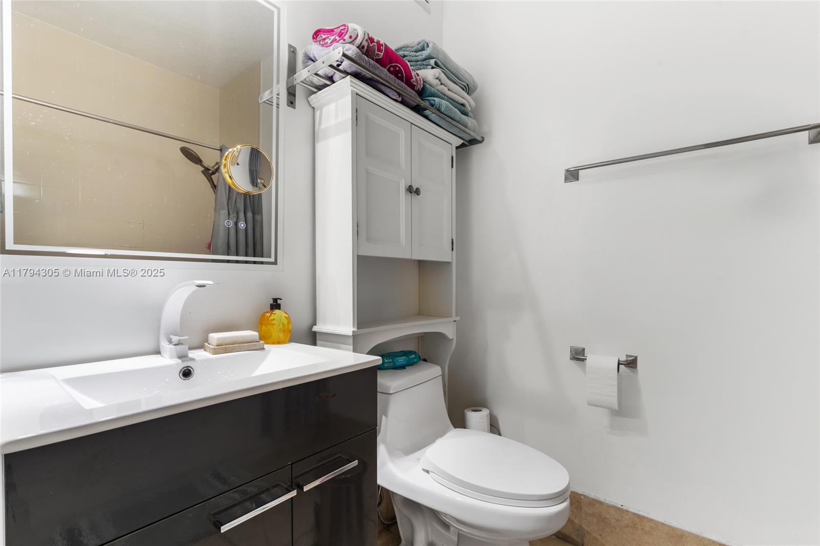 10012 Northwest 7th Street, Unit 107 Miami, FL 33172 - Photo 21 of 44 a bathroom with a sink vanity mirror and toilet