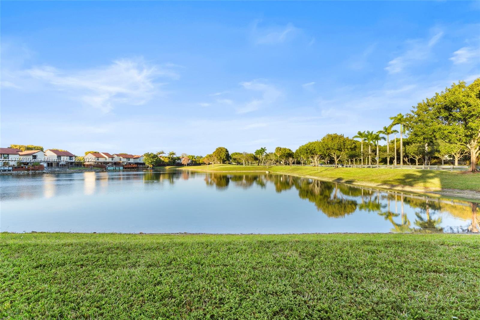10012 Northwest 7th Street, Unit 107 Miami, FL 33172 - Photo 26 of 44 a view of a lake with houses in the back