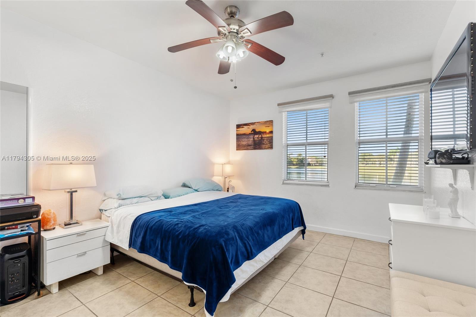 10012 Northwest 7th Street, Unit 107 Miami, FL 33172 - Photo 28 of 44 a bedroom with a bed chandelier and window