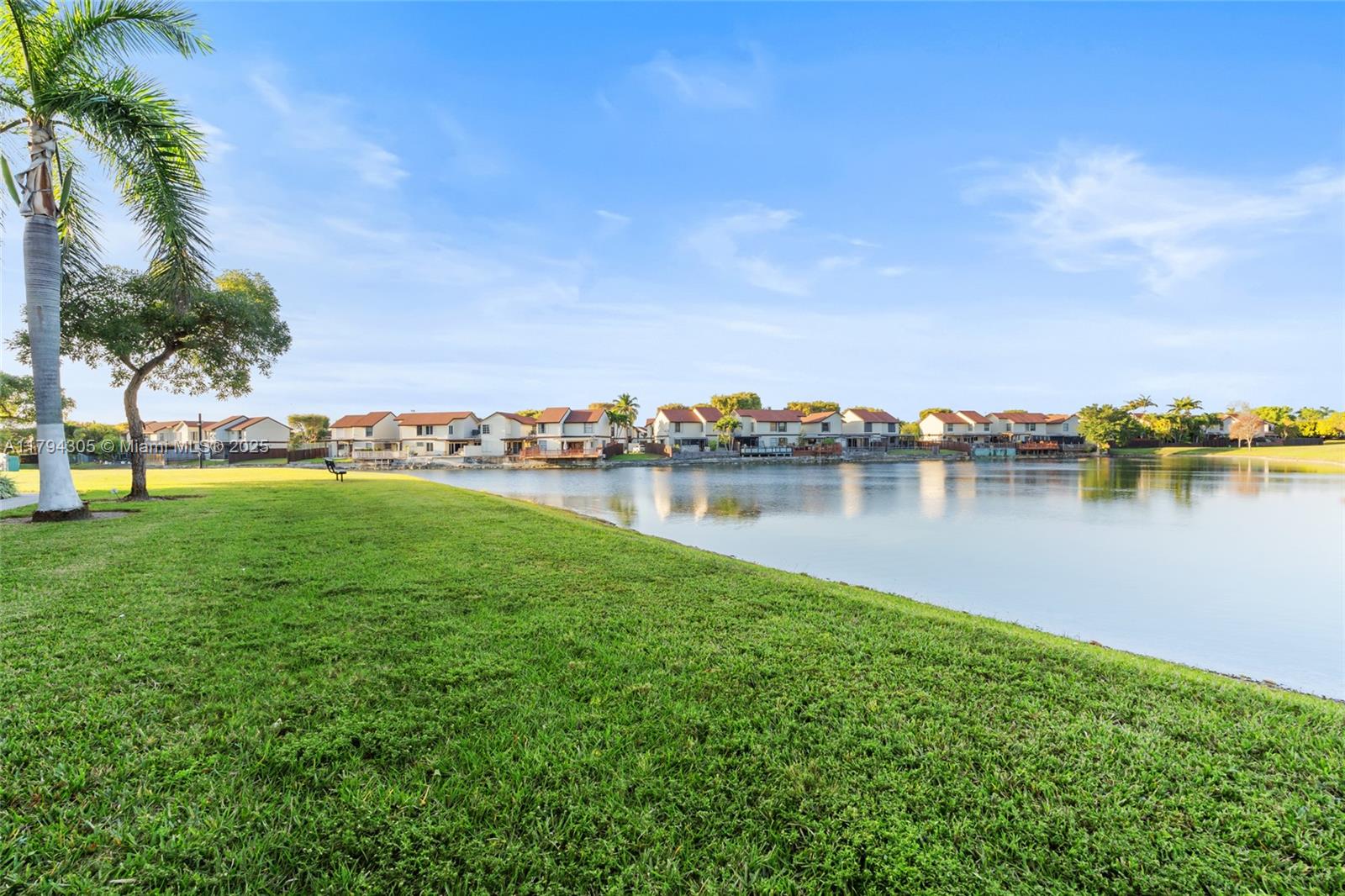 10012 Northwest 7th Street, Unit 107 Miami, FL 33172 - Photo 36 of 44 a view of a lake with houses in the back