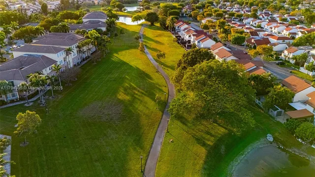 an aerial view of residential building and lake