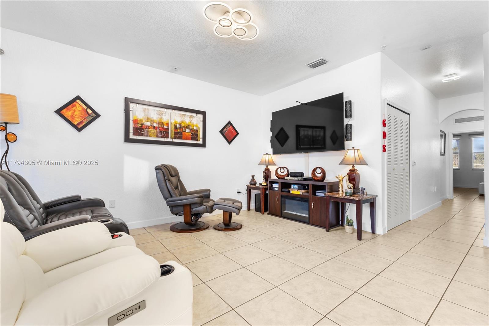 10012 Northwest 7th Street, Unit 107 Miami, FL 33172 - Photo 9 of 44 a living room with furniture and a flat screen tv